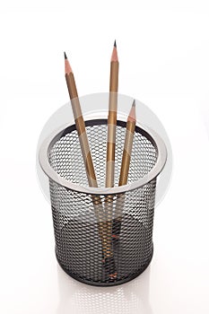 Sharpened pencils in a desktop metal holder in the form of basket