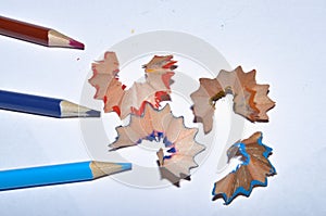 Sharpened pencils of various lengths , pencil shavings and a graphite isolated on white background