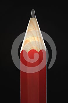 Sharpened red pencil black background