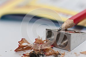 Sharpener, sharpened pencil, crossword in the background.