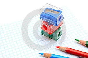 Sharpeners and pencils on a white background.