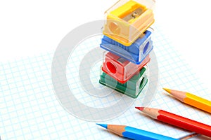 Sharpeners and pencils on a white background.