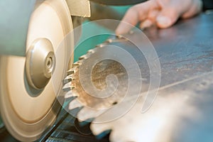 Sharpening Circular Saw, worker sharpens a circular saw blade