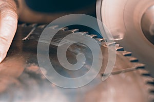 Sharpening Circular Saw, worker sharpens a circular saw blade