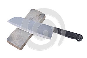 Sharpening or honing a knife on a waterstone, grindstone on the