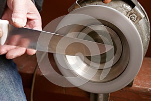 Sharpening a knife on an old emery machine