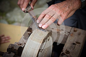 Sharpening knife on old grindstone wheel