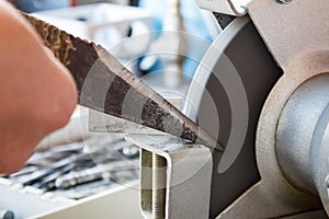 Sharpening knife of a shoemaker on grinding machines