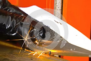 Sharpening throwing knife on a grinding machine