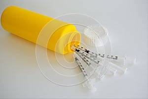 Sharps container for used medical syringes.