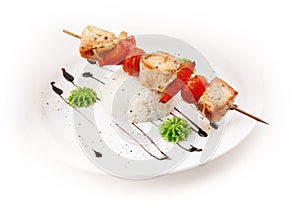 Shashlik from meat, paprika and tomato with rice on white background