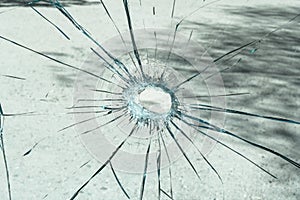 A shattered glass with a hole in the middle.
