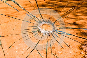A shattered glass with an orange tint.