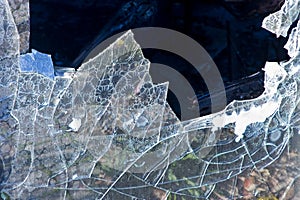 Shattered old broken and sharp glass - abstract background