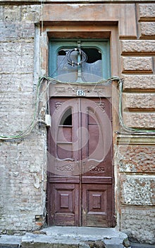 Shattered vintage wooden door surrounded with wires