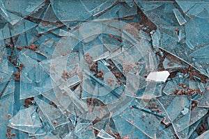 A shattered window on the ground. Broken glass background. Shards