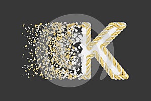 Shattering letter K 3D realistic raster illustration. Twisted letter with explosion effect on dark background.