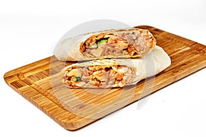 Shaurma or giros pita, roll in pita bread with meat and vegetables photo