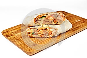 Shaurma or giros pita, roll in pita bread with meat and vegetables