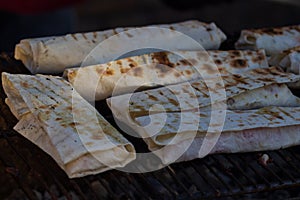 Shaurma, shaurma doner, meat with vegetables in a bread cake, on a light stone or concrete background. Concept restaurant fast foo