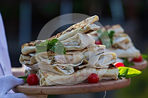 Shaurma, shaurma doner, meat with vegetables in a bread cake, on a light stone or concrete background. Concept restaurant fast foo