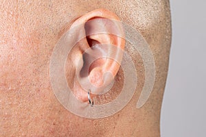 shaved man ear with earring