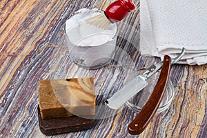 Shaving accessories on a wooden background.