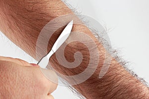 Shaving arm hairs to check sharpness sharpening a scalpel