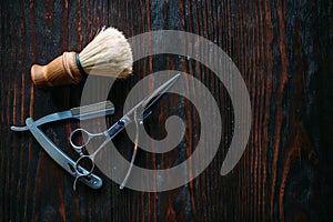 Shaving and barber equipment on wooden background