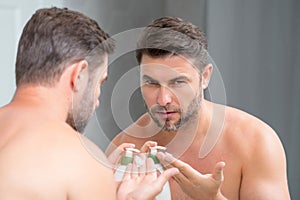 Shaving cream. Beauty man applying cream on skin face. Handsome serious man enjoy fresh perfect skin, applying facial