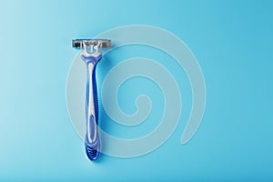 Shaving machine for the face on a blue background top view free space