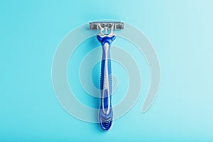 Shaving machine for the face on a blue background top view free space