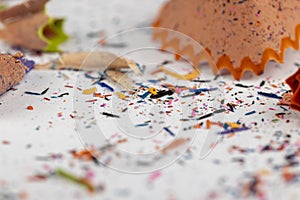 shavings and pieces of lead on paper after sharpening pencils