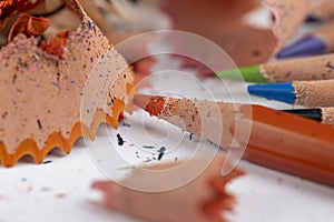 shavings and pieces of lead on paper after sharpening pencils