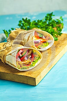 Shawarma sandwich with grilled meat, vegetables, cheese