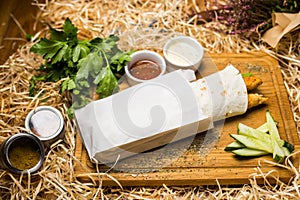 Shawerma on wooden plate in studio