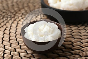 Shea butter in bowl on wicker mat