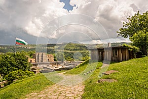 A shed and the Bulgarian flag over gate in Veliko Tarnovo castle