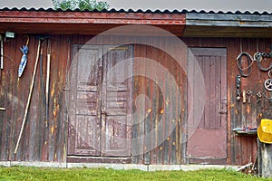Shed With Old Wooden Doors and Fishing Tackles Hinged on Wall