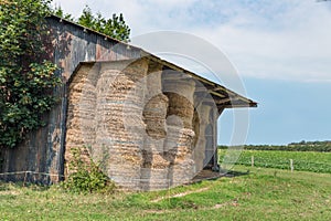 Shed with pile of haystacks in Normandy, France