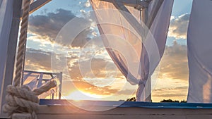 Sheds awning with fabric curtains on the beach in the evening photo