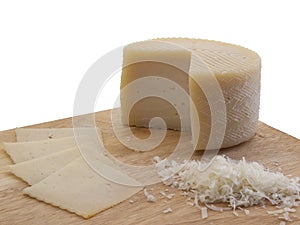 Sheep cheese with spots and scratches on a kitchen cutting board photo
