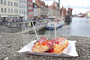 Sheep fried cheese with cranberry sauce. Street food on the embankment in Gdansk.