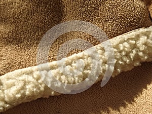 Sheep fur on a suede natural product. Fur edge on winter clothes. close-up. macro photo