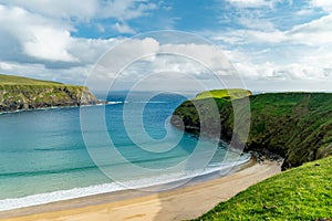 Sheep grazing near Silver Strand, a sandy beach in a sheltered, horseshoe-shaped bay, situated at Malin Beg, near Glencolmcille,