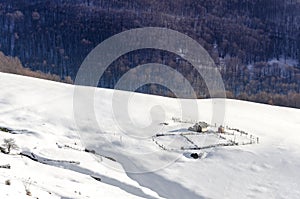 Sheep herd house on winter snow mountain plateau