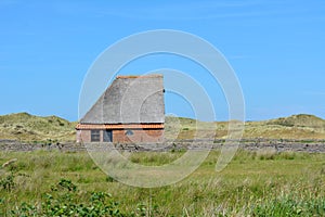 Sheep shelter bungalow building in national park De Muy in the Netherlands on Texel photo