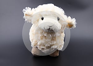 Sheep toy on a black background