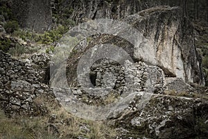 Sheepfold with a stone wall under a boulder to keep in livestock - Manteigas photo