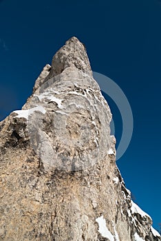 Sheer cliff against dramatic blue skies